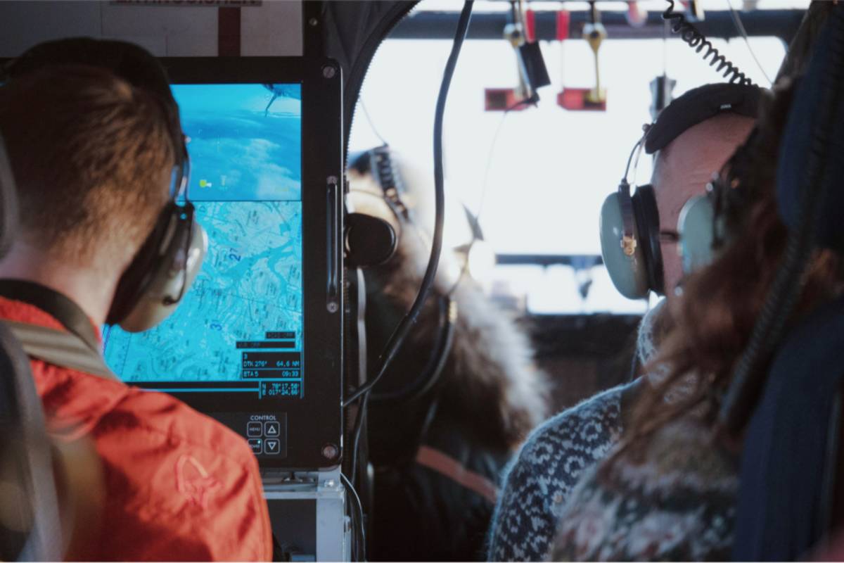 Researchers inside a helicopter