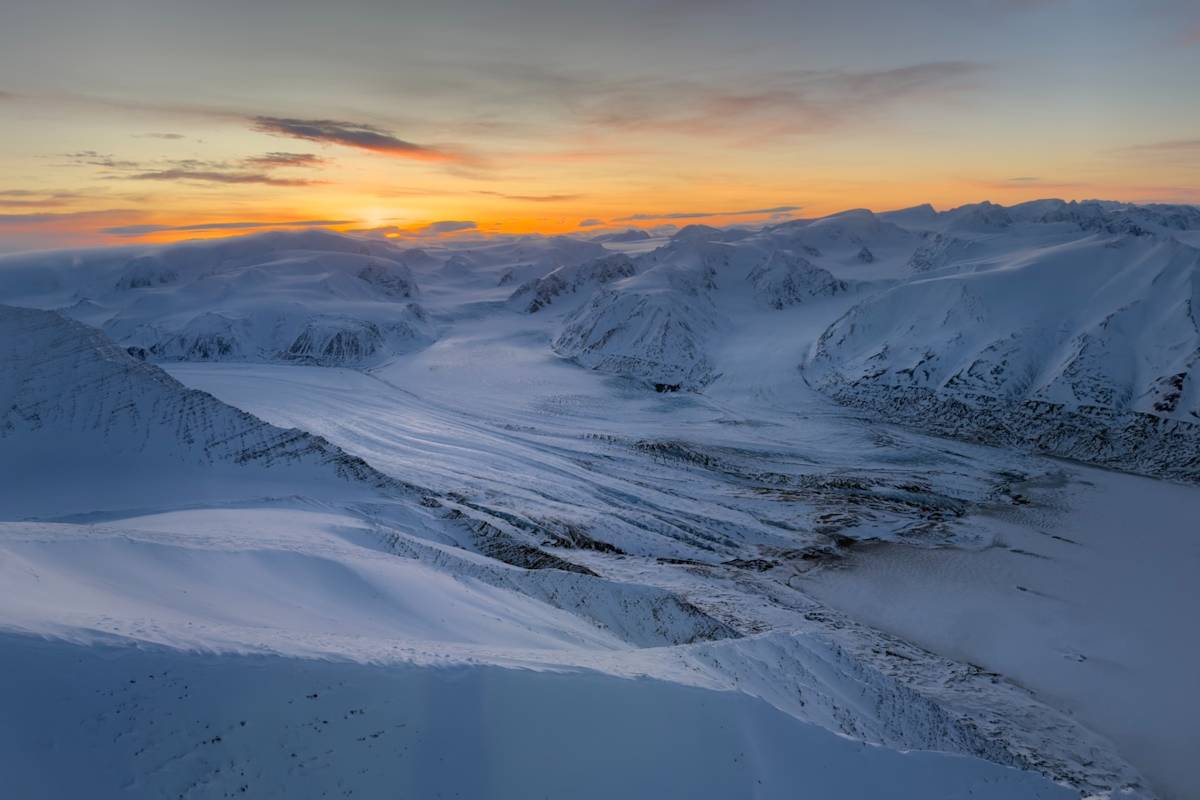 The sunset over snowy mountains in Svalbard