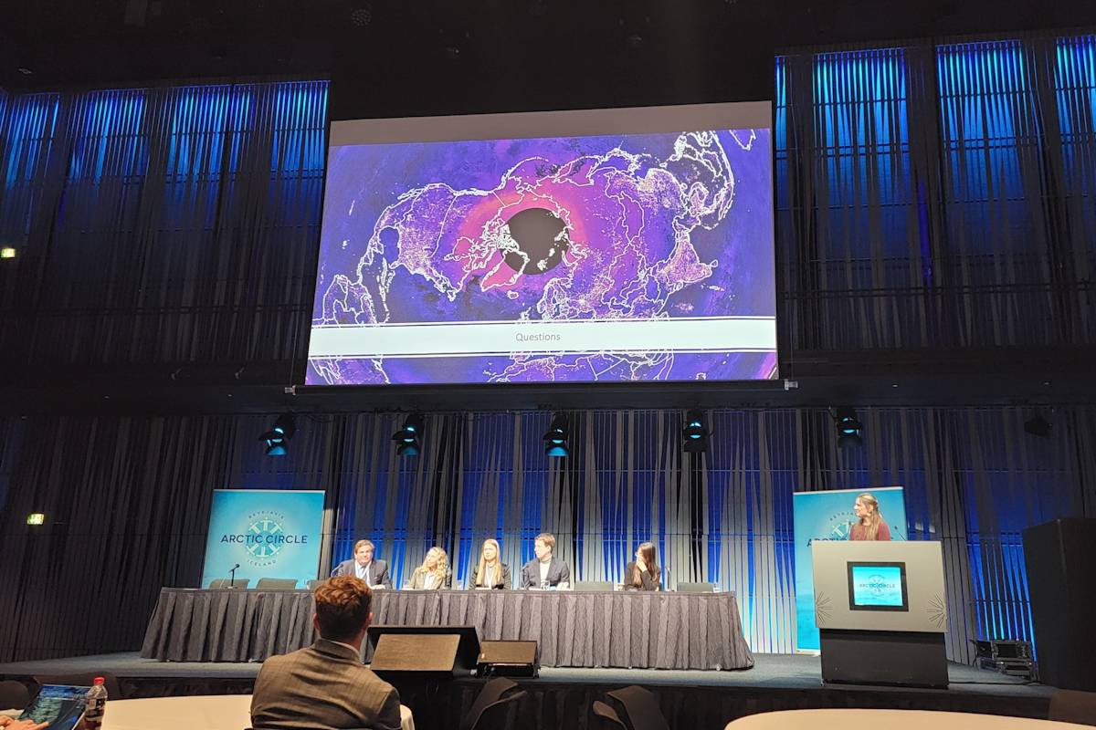 The stage at Arctic Circle Assembly 2024, showing a photo of the circumpolar Arctic