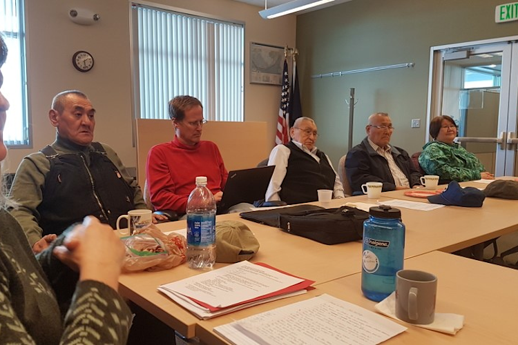 Alaskan Native experts sitting at a meeting table