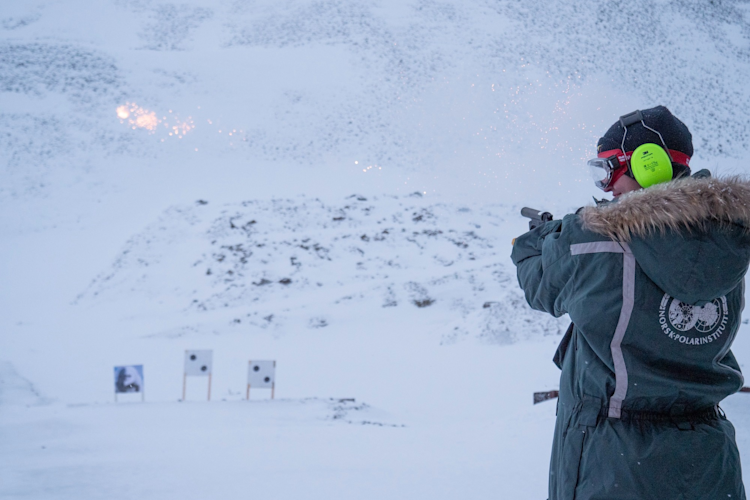 Louise Archer fires a flare gun during training in Svalbard