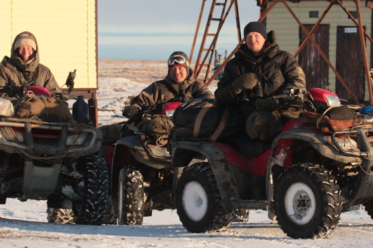 The polar bear research team prepares to head out on ATVs.